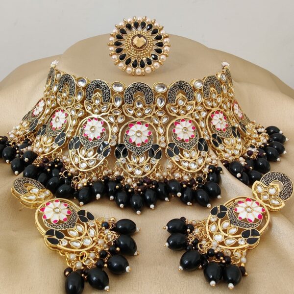 Choker Set Of Meenakari And Kundan Jewellery Design Made Of Brass Metal And Gold Plated. Kundan beads dangling in Black colour, beautiful earrings, mang-tika and Rings will look great at your wedding. These exquisite pieces of jewellery are a piece of art, handmade to perfection and have a timeless appeal.