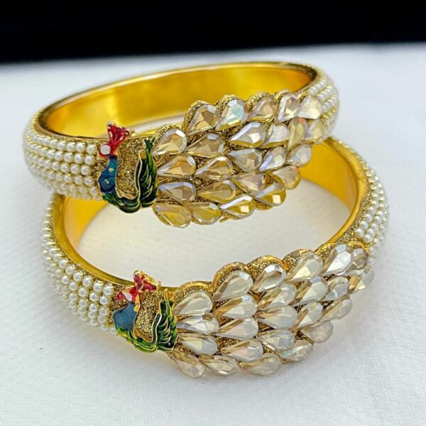 Beautiful bangle made in the shape of peacock which is made of brass and the polish is also made of brass Stone type is artificial beads