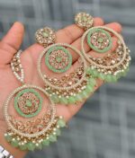 Beautiful premium quality reverse Ad Gossip green coloured artificial stone, pearl earrings and tilak made of base metal alloy and gold plated and presented in hand holding
