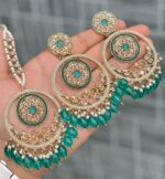 Beautiful premium quality reverse Ad Ocean green coloured artificial stone, pearl earrings and tilak made of base metal alloy and gold plated and presented in hand holding