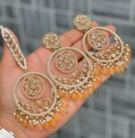 Beautiful premium quality reverse Ad melon orange coloured artificial stone, pearl earrings and tilak made of base metal alloy and gold plated and presented in hand holding